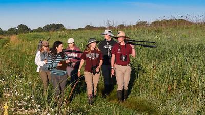 group walking in field at rafc with observation gear