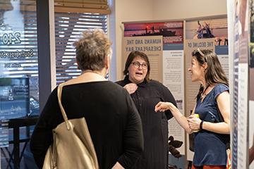 Three people talk in an exhibit at MuSE.